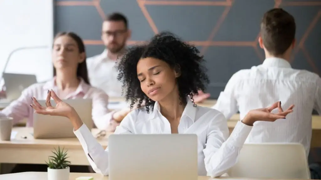 Employees practicing mindfulness at work to promote well-being and support in a balanced workplace environment.