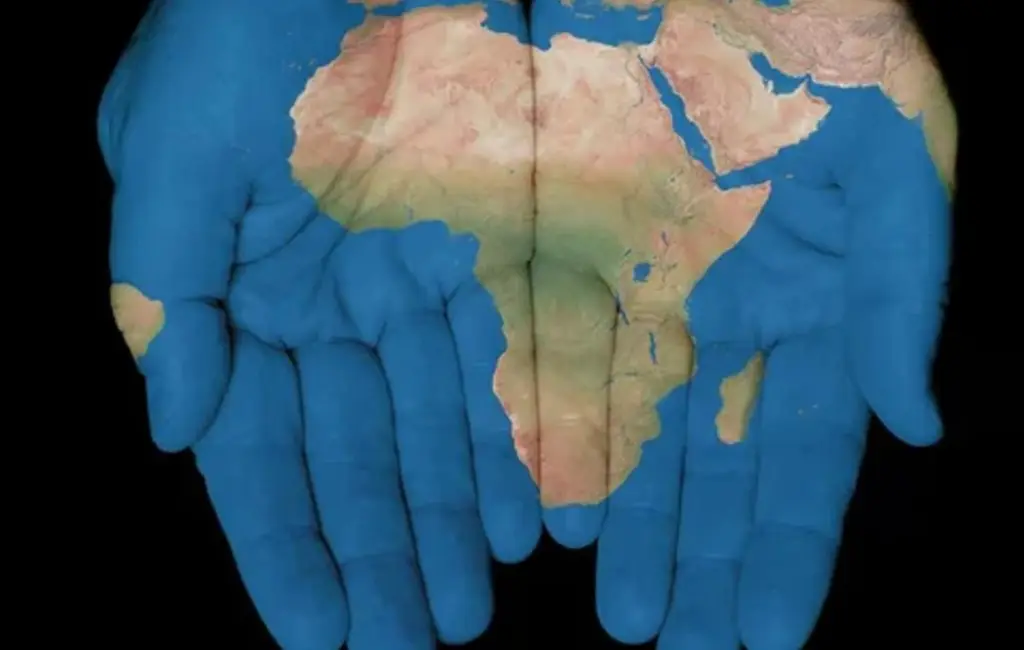 Hands painted with a world map highlighting Africa, symbolizing unity, care, and responsibility for life and the planet.